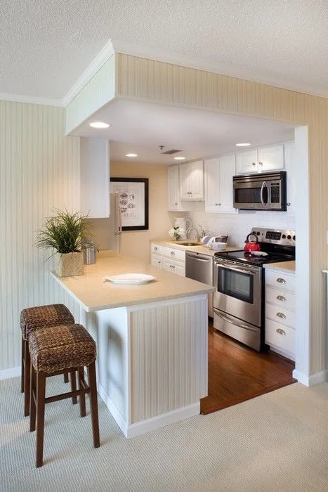 Compact Kitchen Layout with Peninsula and Cream Beadboard Detailing