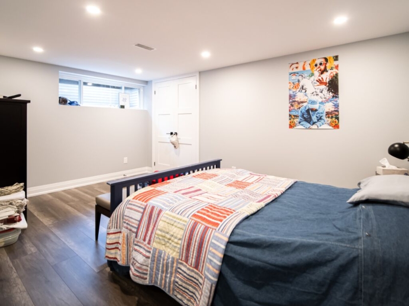 Contemporary Basement Bedroom with Patchwork Quilt and Slatted Bed Frame