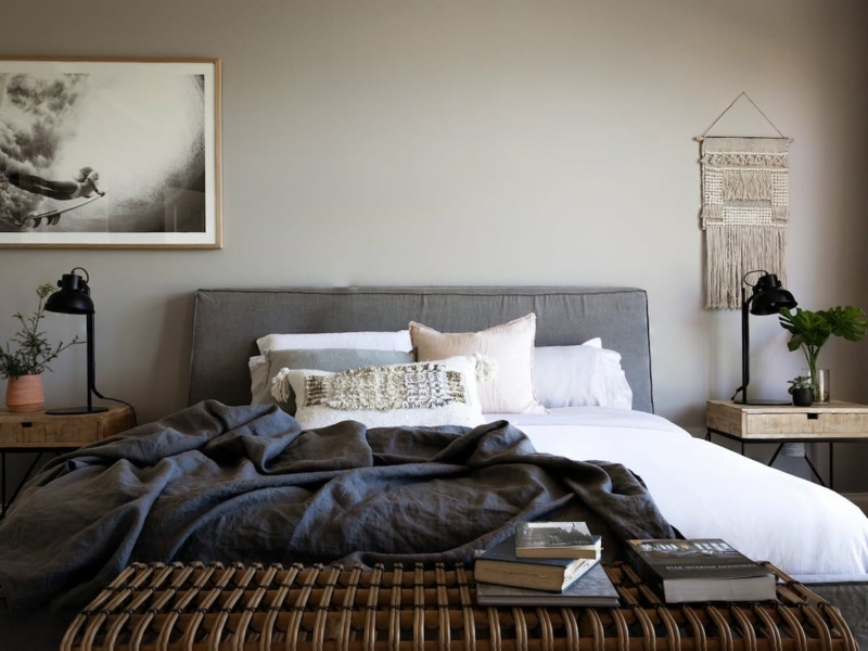 Contemporary Bed with Charcoal Linen Bedding and Rattan Bench