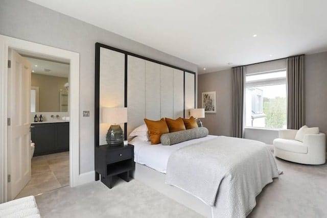 Contemporary Bedroom with Plush Gray Carpet and Mustard Yellow Accents