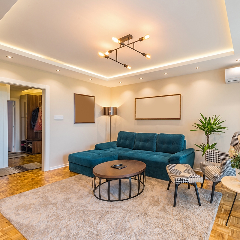 Contemporary Chandelier with Teal Sectional and Cage Table