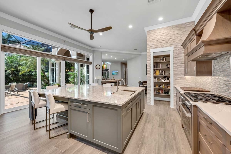 Contemporary Kitchen with Large Grey Island and Textured Pantry Wall