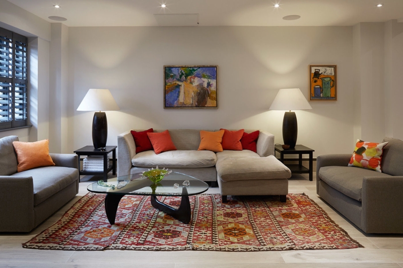 Contemporary Living Room Layout Geometric Area Rug Symmetrical Lamps