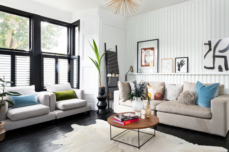 Contemporary Living Room with Black Architectural Trim and Cowhide Rug