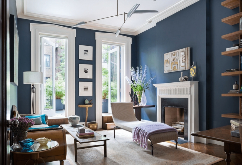 Contemporary Living Room with Navy Blue Walls and Built-In Shelving
