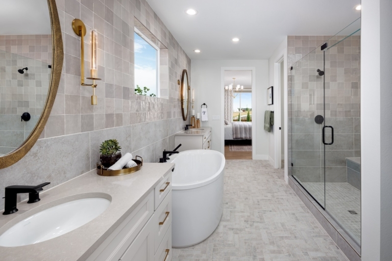 Contemporary Master Bath with Herringbone Tile Floor and Gold Accents