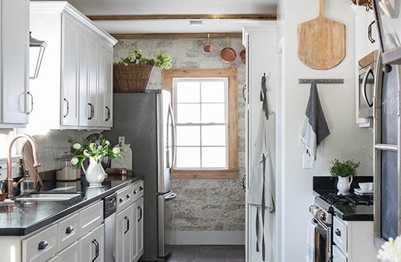 Cottage Kitchen Stone Accent Wall featuring Hanging Copper Pots