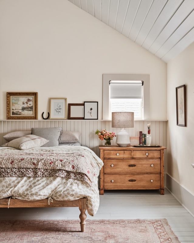 Cozy Attic Bedroom with Beadboard Wainscoting and Floral Quilt