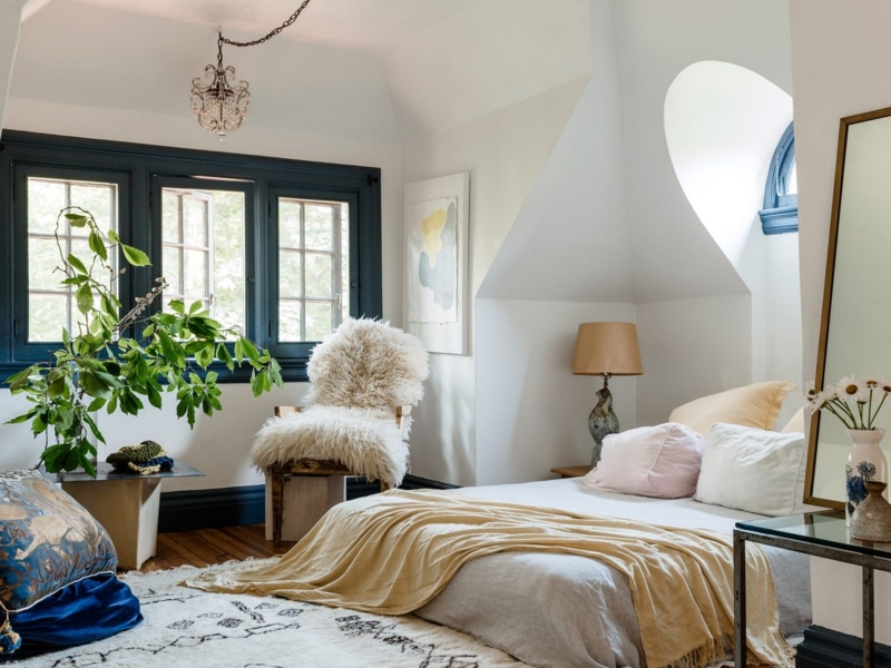 Cozy Attic Bedroom with Sloped Ceiling and Navy Window Trim