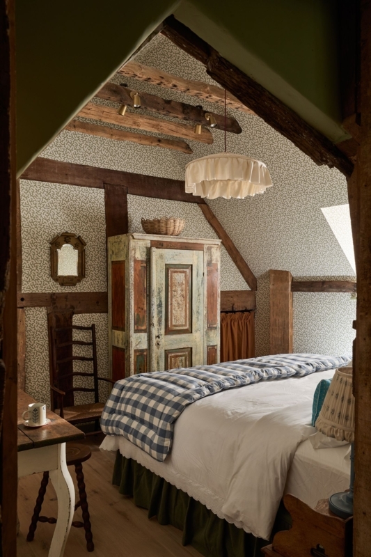 Cozy Attic Cottage Bedroom with All-Over Wallpaper and Exposed Beams