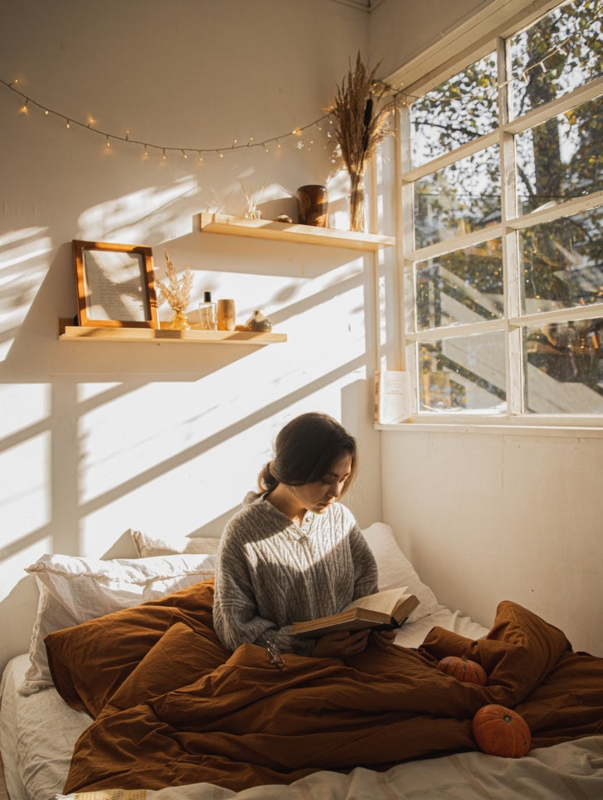 Cozy Bedroom Nook: Warm Golden Hour Lighting, Floating Shelves.