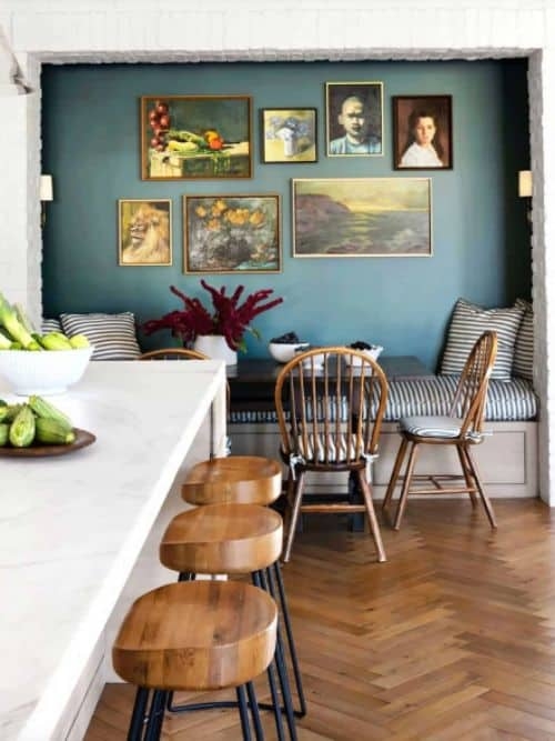 Cozy Built-in Breakfast Nook with Teal Wall and Vintage Gallery