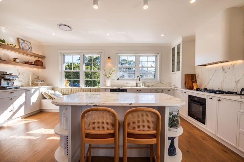 Cozy Kitchen Breakfast Nook Seating with White Cabinetry and Marble