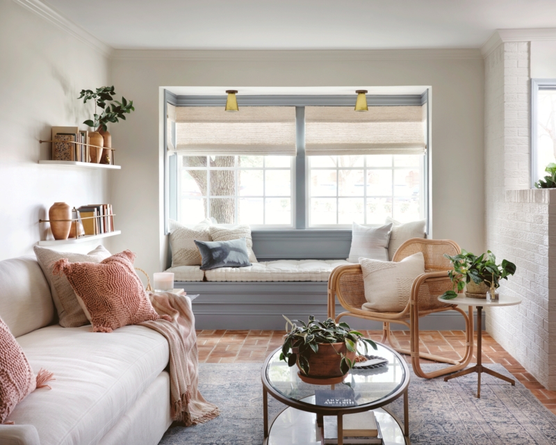 Cozy Living Room Window Seat with Exposed Brick Flooring and Area Rug