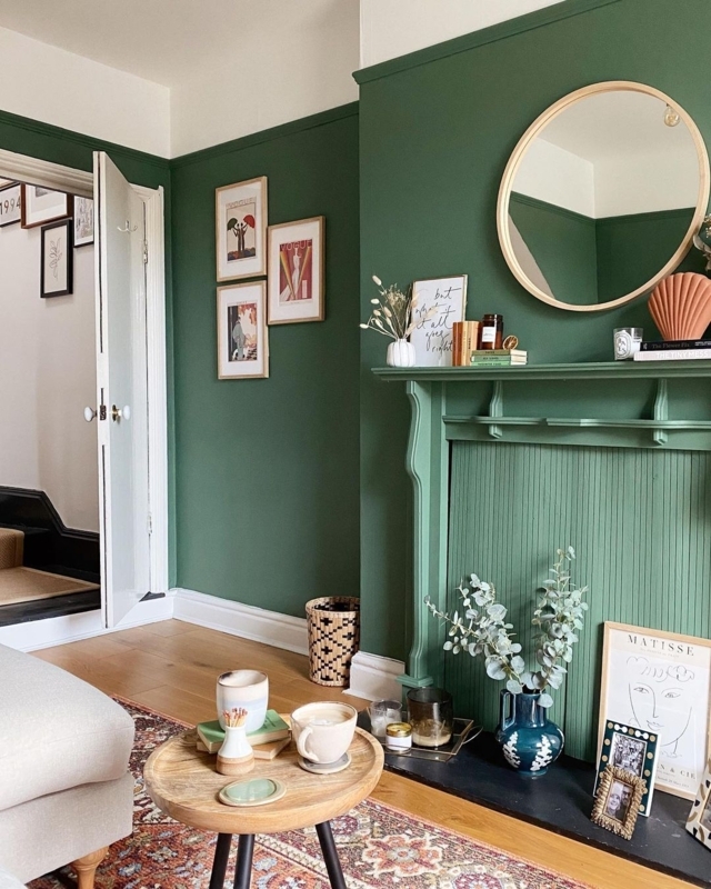 Cozy Living Room with Forest Green Walls and Ribbed Mantel Texture