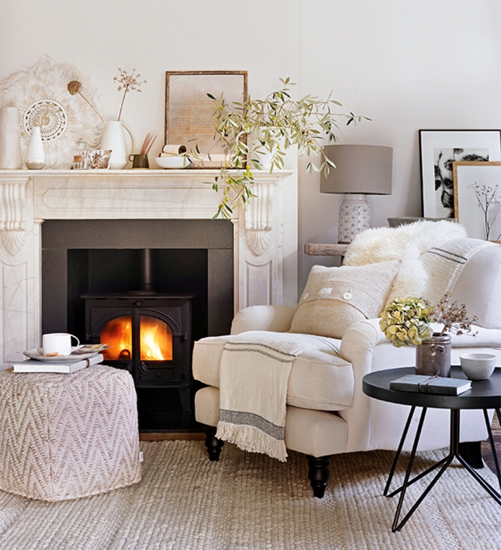 Cozy Living Room With Marble Mantel And Wood Burning Stove