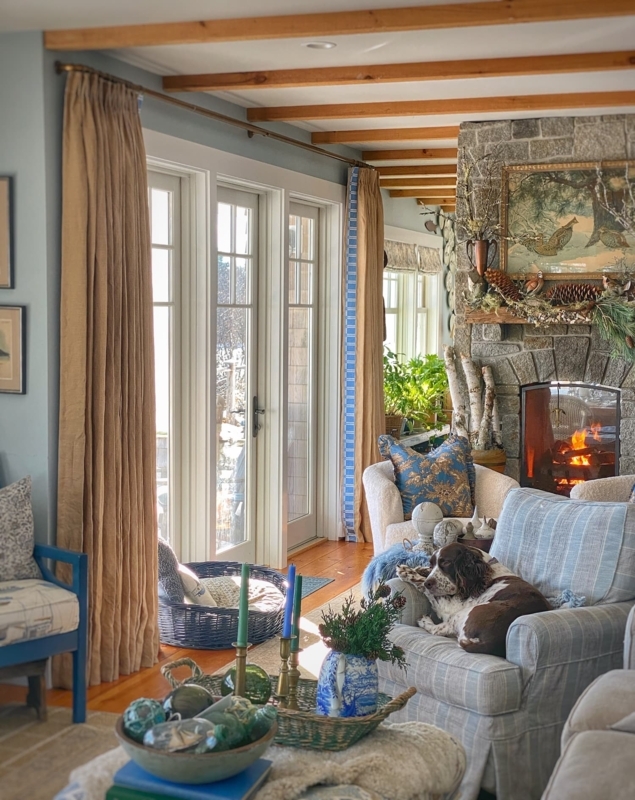 Cozy Living Room with Stone Fireplace and Blue Plaid Accent Chair