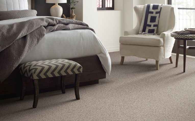 Cozy Transitional Bedroom with Textured Taupe Flooring and Chevron Bench