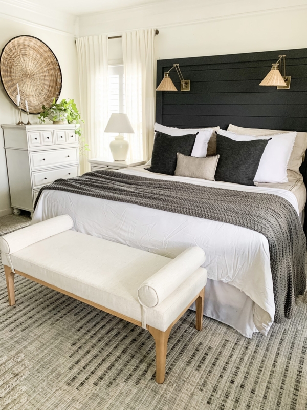 Cream Upholstered Bench with Bolster Arms at Foot of Bed