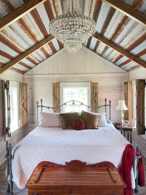 Crystal Chandelier on Corrugated Metal Ceiling Rustic Glam Bedroom