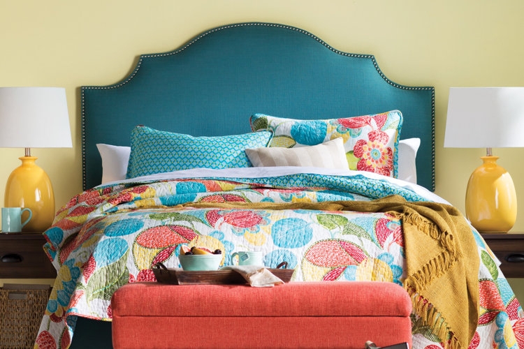 Curved Headboard with Nailhead Trim and Floral Quilt Bedding