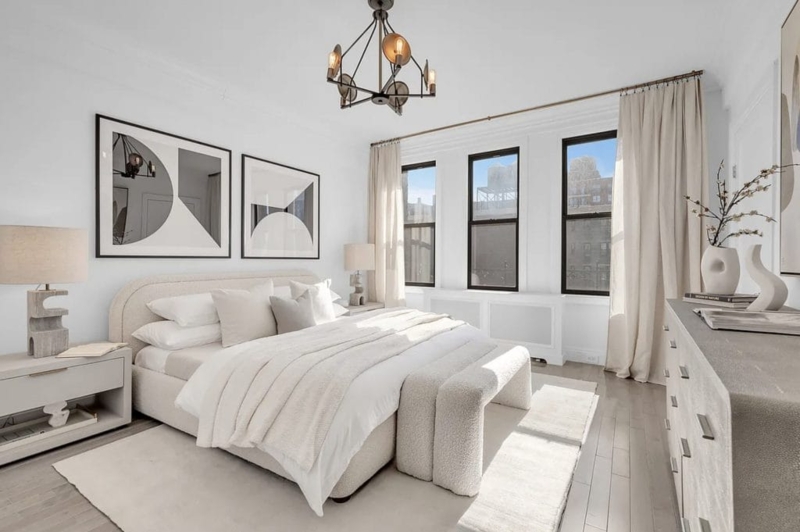 Curved Upholstered Bed and Black Framed Windows in Scandinavian Bedroom