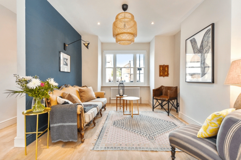 Curved Vintage Sofa against Deep Blue Accent Wall Living Room