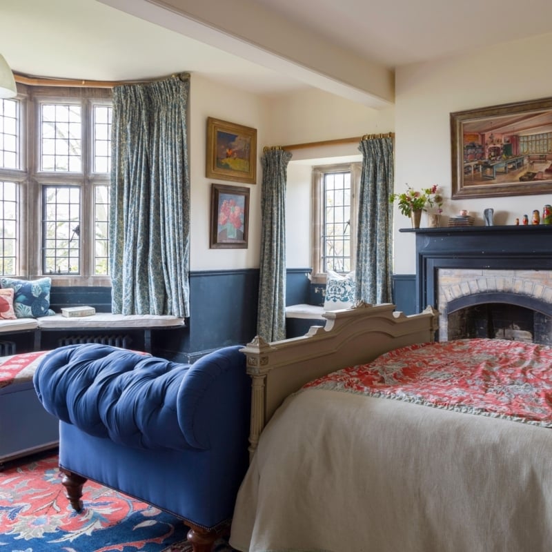 Dark Blue Wainscoting with Tufted Bench in Traditional Bedroom