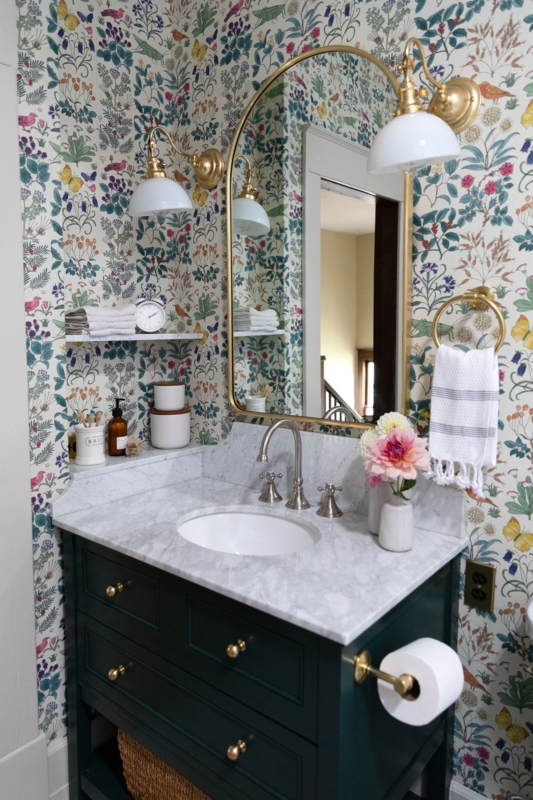 Dark Green Bathroom Vanity with Marble Top and Arched Gold Mirror