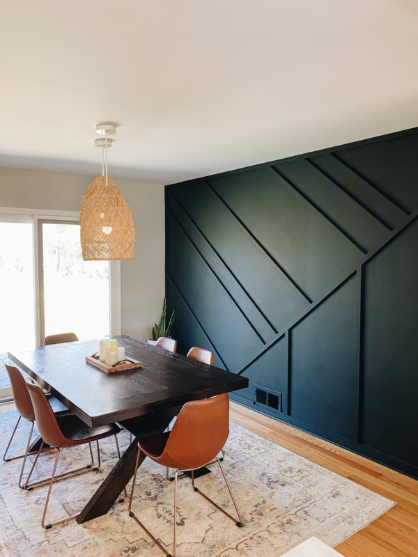 Dark Green Geometric Accent Wall and Cognac Leather Dining Chairs