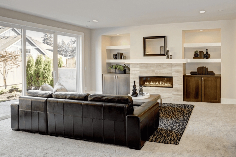 Dark Leather Sectional Styling with Modern Linear Fireplace Layout