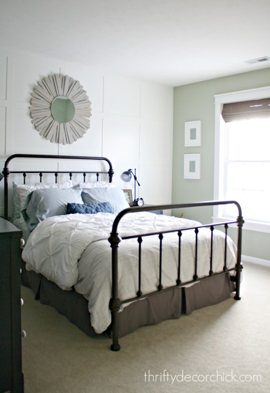 Dark Metal Bed Frame against Square Paneled Accent Wall Feature