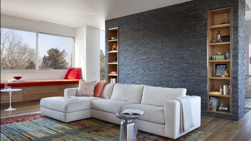 Dark Stone Accent Wall Living Room with Built-in Window Seating Bench