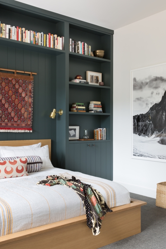 Dark Teal Built-in Shelving Framing a Minimalist Platform Bed