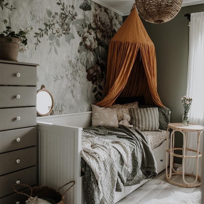 Daybed with Mustard Canopy and Rattan Side Table in Floral Bedroom