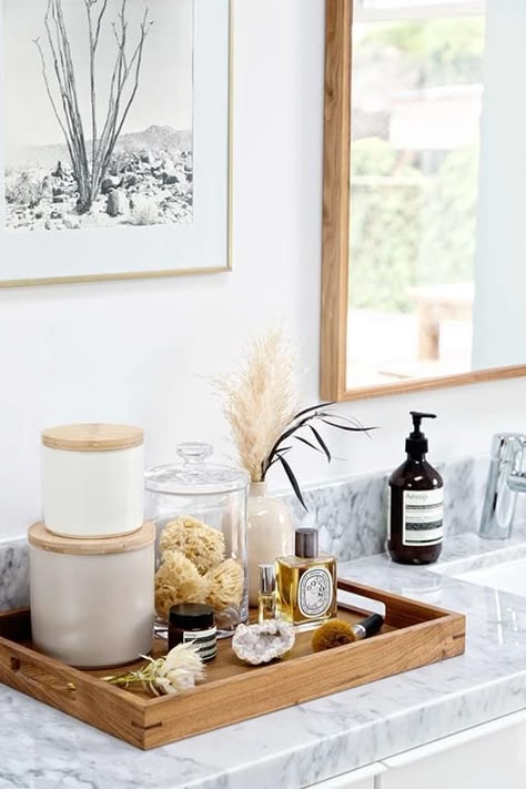 Decorative Tray in wood with stacked ceramic canisters. SEO: spa-like vanity countertop decor.