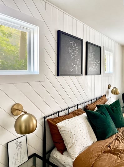 Diagonal White Shiplap Wall with Brass Globe Sconces