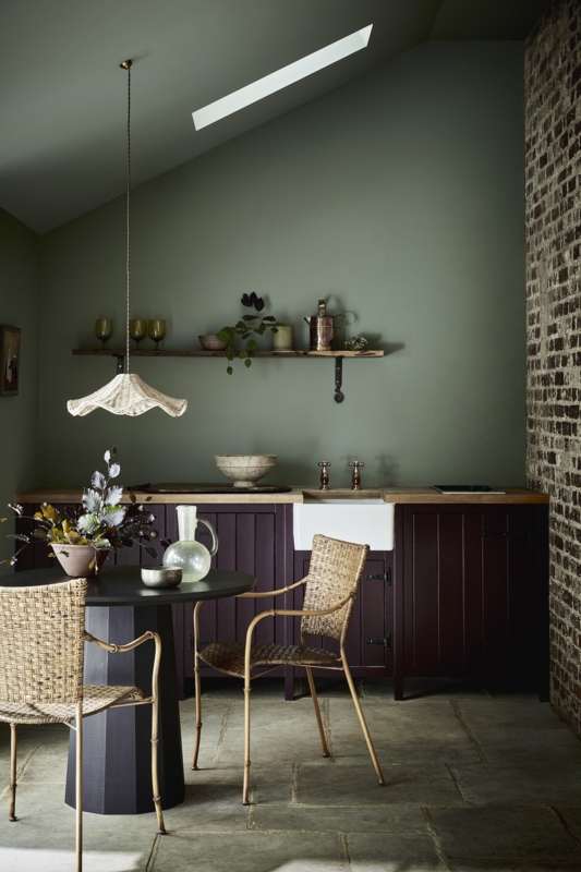 Dining Room Nook with Burgundy Cabinets and Exposed Brick Wall