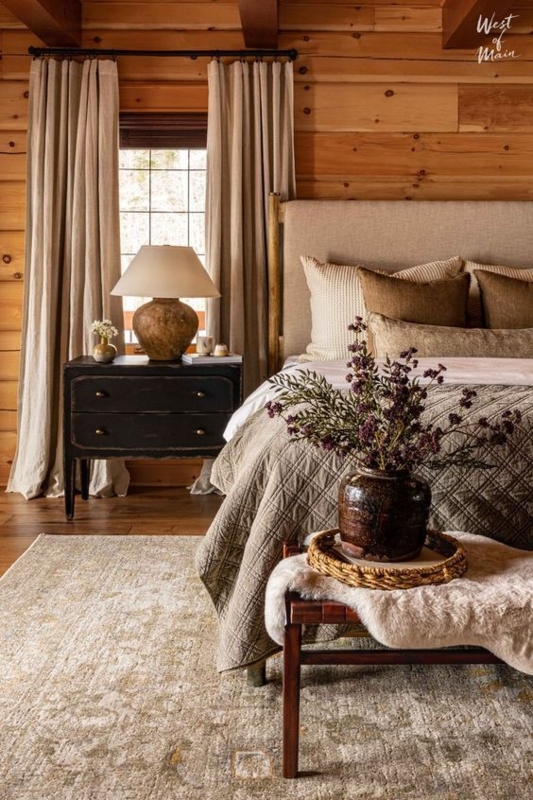 Distressed Black Nightstand Styling In Rustic Bedroom With Wood Walls