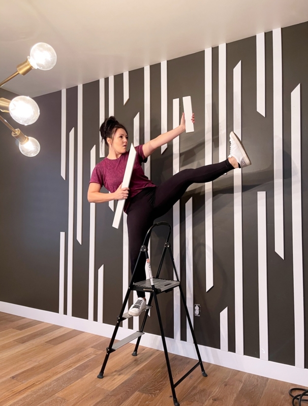 DIY Staggered Vertical Wood Slat Design on Charcoal Accent Wall