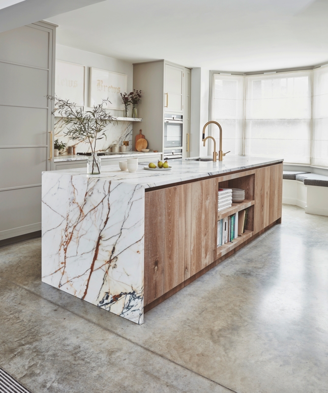 Dramatic Marble Waterfall Kitchen Island with Bookshelf