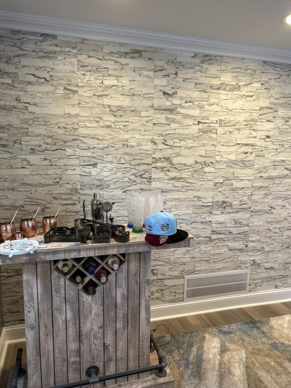 Earthy Home Bar Cabinet with Distressed Finish against Stacked Stone Wall