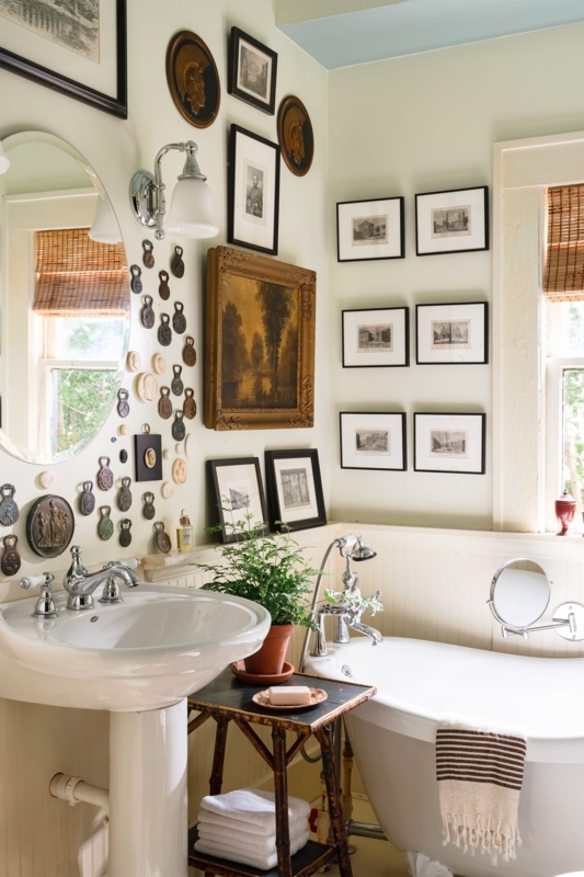 Eclectic Bathroom Wall Decor: Dense Art Wall and Bamboo Side Table