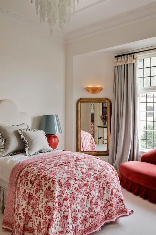 Eclectic Bedroom featuring a Scalloped Headboard and Red Floral Quilt