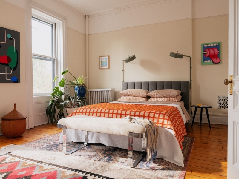 Eclectic Bedroom With Orange Accents And Olive Swing Arm Lamps