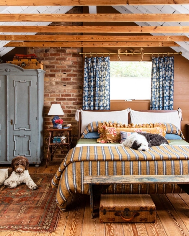 Eclectic Farmhouse Bedroom with Exposed Brick Headboard Wall