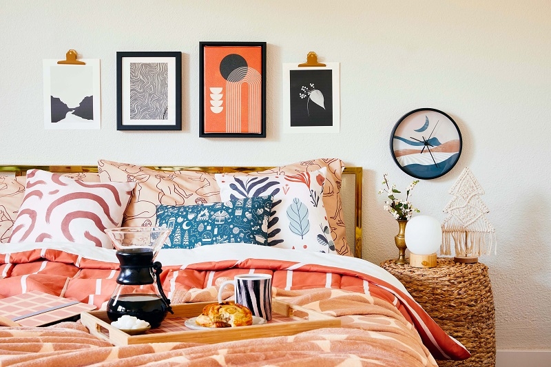 Eclectic Gallery Wall Above Bed with Terracotta and Navy Palette