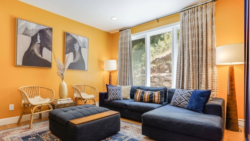Eclectic Geometric Curtains in Orange Room with Rattan Accent Chairs