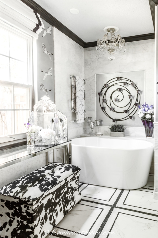 Eclectic Glam Bathroom with Cowhide Print Bench and Spiral Wall Art