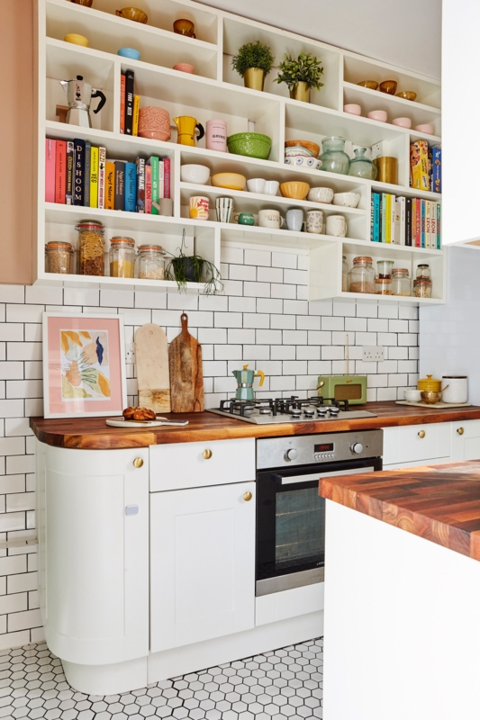 Eclectic Kitchen Shelving filled with a Rainbow Cookbook Display